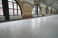 a picture of a room with huge windows and bricks on it and the floor is shiny