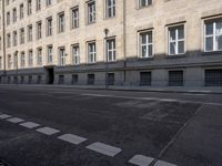 a black and white photo of a street and buildings in italy, next to a crosswalk