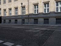 a black and white photo of a street and buildings in italy, next to a crosswalk