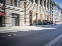 people walking and riding their bikes in the city streets are blurry as the car is passing by