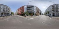 an upside down photo of a street in europe as seen through an intersection mirror's fisheye lens