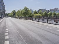 a empty street next to buildings in the city, with a bike lane and pedestrian crossing