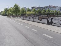 a empty street next to buildings in the city, with a bike lane and pedestrian crossing