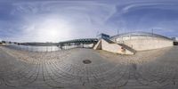 a mirror shows the view of an outdoor park with lots of cobbles and stones