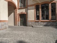 the paved streets of a european city are cobblestone bricked and bricked