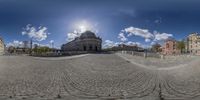 360 - view of cobblestone road in city area with large dome building and sky in background