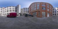 the street view of a truck in the center of a city with buildings in the background