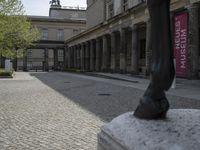 there is a horse statue next to some buildings and cobblestones in the street