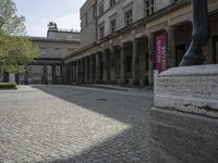 there is a horse statue next to some buildings and cobblestones in the street