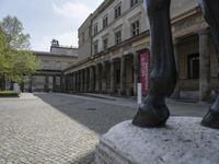 there is a horse statue next to some buildings and cobblestones in the street