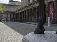 there is a horse statue next to some buildings and cobblestones in the street