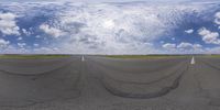 a curved road with sky and clouds in the background and an overhead shot of the roadway