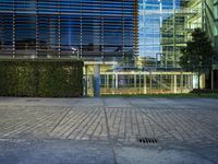 a woman standing in the street outside of an office building with no doors on it