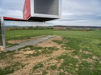 an upside down building in a grassy field on top of a hill with some grass