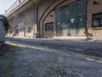 an image of a deserted street by some large buildings on the side of the road