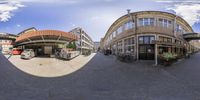 a picture of the streets and buildings from a fish eye lens looking at them in their different sides