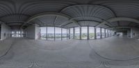 a 360 - camera picture of an empty building on the outside, a sky view is shown through the window