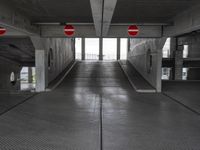 an empty parking garage with no people or vehicles in it and sign indicating no parking inside