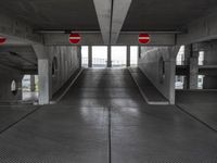 an empty parking garage with no people or vehicles in it and sign indicating no parking inside