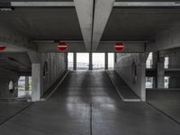 an empty parking garage with no people or vehicles in it and sign indicating no parking inside