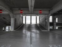 an empty parking garage with no people or vehicles in it and sign indicating no parking inside