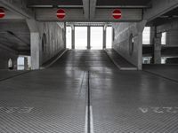 an empty parking garage with no people or vehicles in it and sign indicating no parking inside