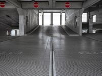 an empty parking garage with no people or vehicles in it and sign indicating no parking inside