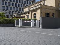 an entrance to the city with security gate open on the road and in front of it is buildings