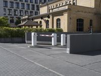 an entrance to the city with security gate open on the road and in front of it is buildings