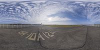 this image is taken from inside the fish eye lens while showing a runway with buildings in the distance