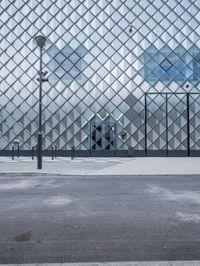 a person is holding a backpack standing outside the louvre's glass pyramid entrance in paris