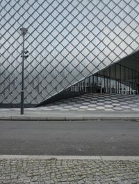 a person is holding a backpack standing outside the louvre's glass pyramid entrance in paris