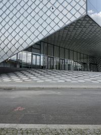 a person is holding a backpack standing outside the louvre's glass pyramid entrance in paris