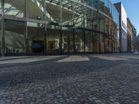 Berlin, Germany: Glass Wall on Cobblestone