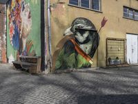 a colorful painted bird is painted on the side of the building by graffiti artist in riga