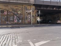 there is an overhead view of a graffiti covered building on a street corner, with car parking spaces in front of it