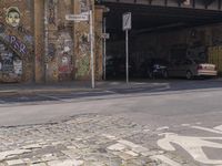 there is an overhead view of a graffiti covered building on a street corner, with car parking spaces in front of it