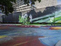 a kid rides a skateboard across a colorful field of paint in front of a building