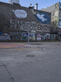 a skateboarder performing a trick off a wall in front of some graffiti covered buildings