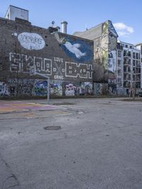 a skateboarder performing a trick off a wall in front of some graffiti covered buildings