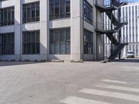 an empty parking lot with stairs and windows in front of it for people to climb