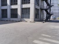 an empty parking lot with stairs and windows in front of it for people to climb