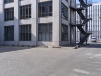 an empty parking lot with stairs and windows in front of it for people to climb