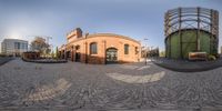 a 360 - view of a brick structure at an urban park with various buildings and trees