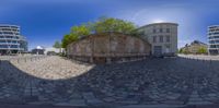 the panoramic lens is focused on the circular structure in this photo, with a view of the building