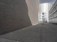 this is a picture of a brick wall and road in front of a building that looks like a wall