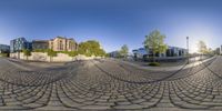 the fish eye view shows many small buildings and cobblestone streets in an intersection