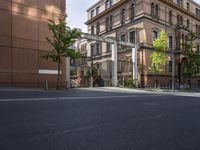 this is a picture of a street corner in front of an apartment complex and two story building