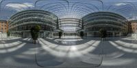 a panoramic view of a modern city building taken through a spherical glass roof