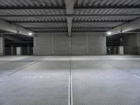 an empty parking garage with a sign indicating to wait for the next step down stairs